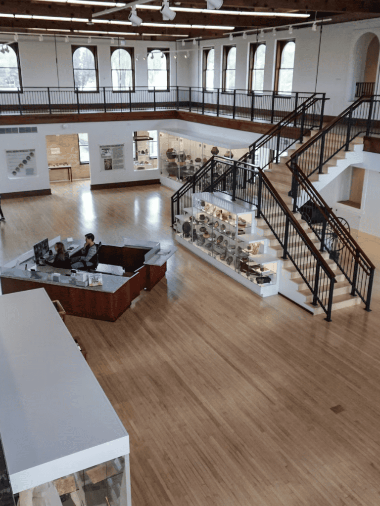 Accessible museum interior with staircase and exhibit displays.