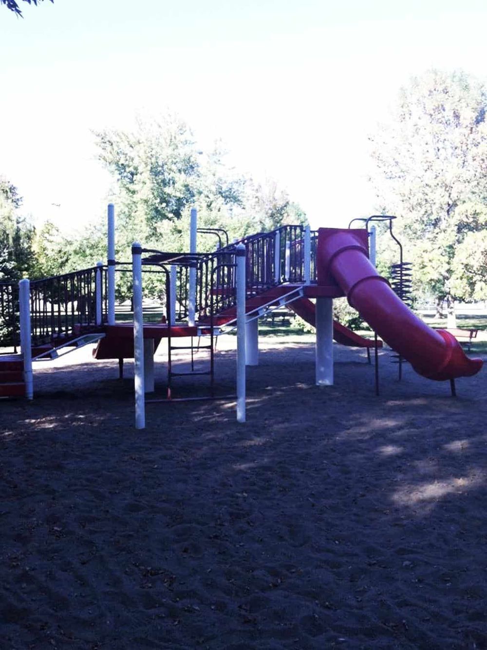 Colorful kids playground slide structure with tunnels and climbing areas at QuestForDirections park.