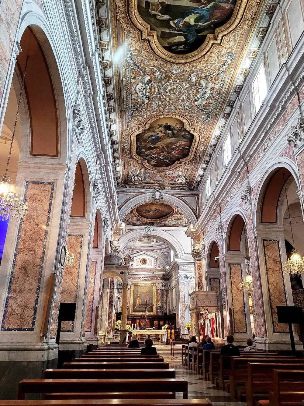 Ornate church interior with lavish ceiling murals and detailed architecture, perfect for historical and religious site searches.