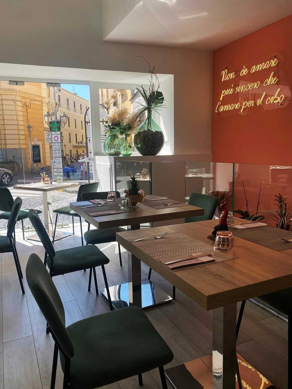 Cozy modern restaurant interior with large windows, stylish table setting, and artistic decor for memorable dining experiences.