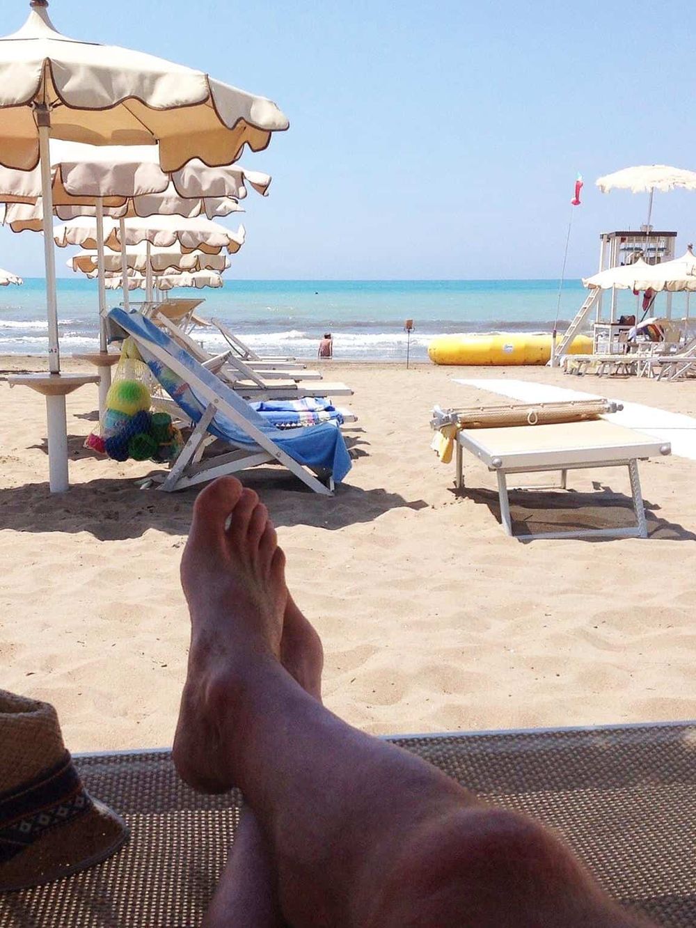 Relaxing beach scene with lounge chairs, umbrellas, and ocean view, ideal for beach vacations and seaside getaways.