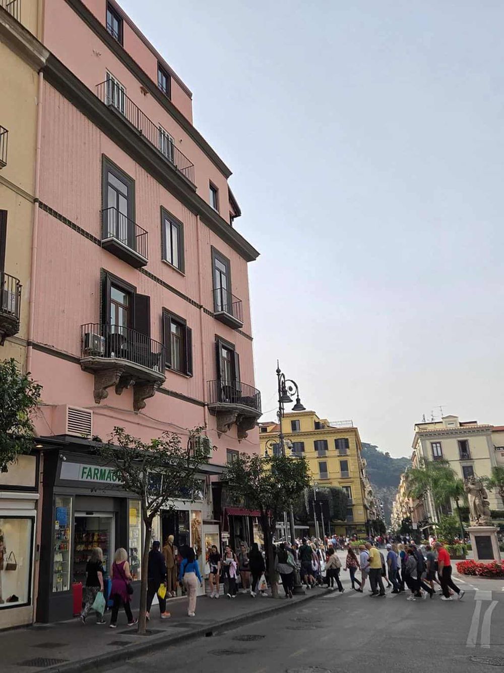 Colorful city street with shops, pedestrians, and historic buildings, perfect for exploring local culture and landmarks.