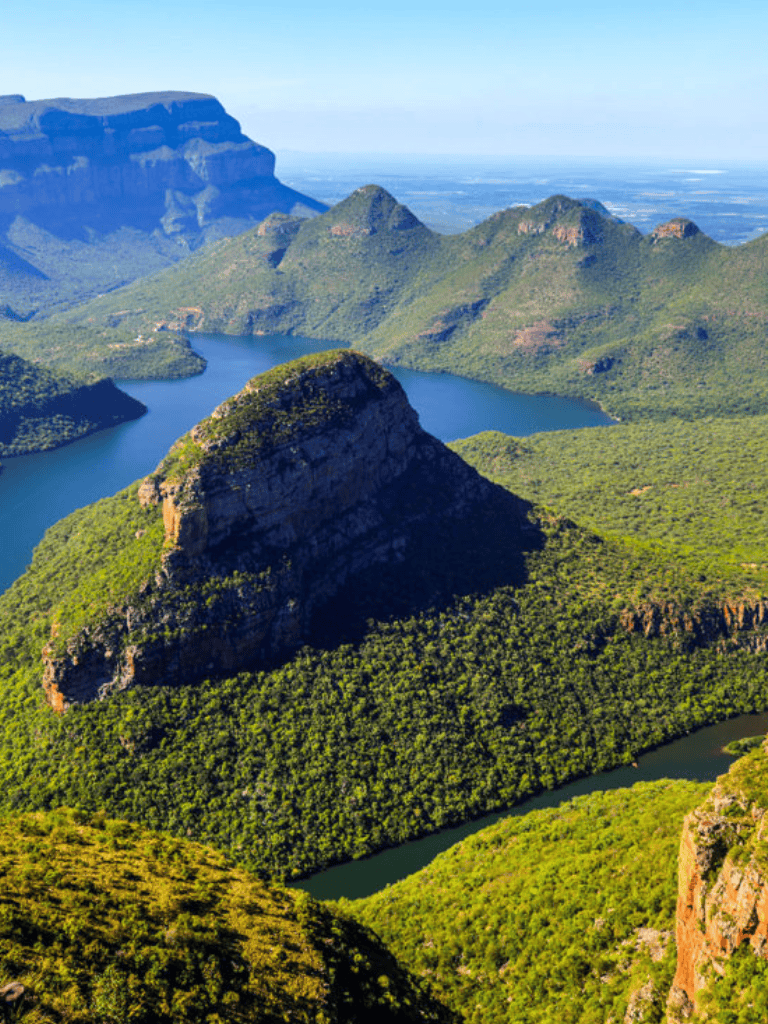 Vast green mountains and winding river in a lush national park landscape.