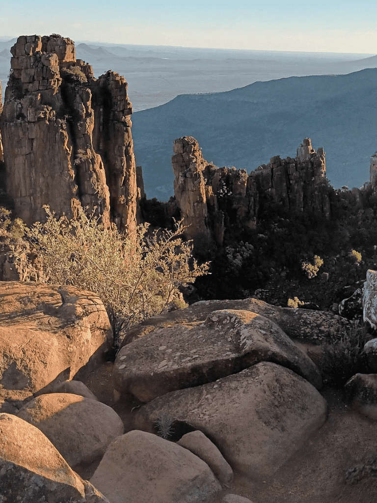 Rugged mountain landscape with rock formations and sparse vegetation, scenic outdoor adventure destination.