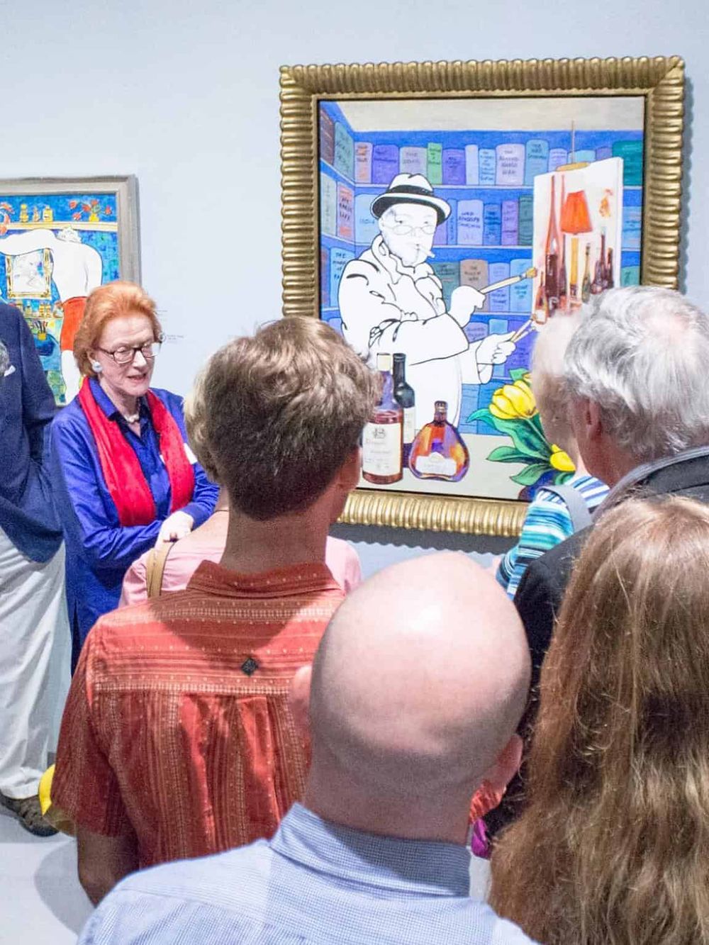 Vibrant art event showcasing a diverse group viewing colorful paintings in an art gallery. Visitors engage with exhibited contemporary artwork.