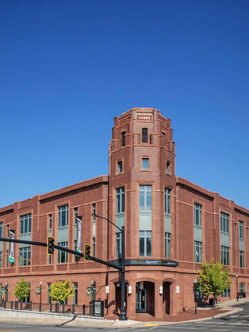 Colorful downtown hotel building with bright blue sky in the background.