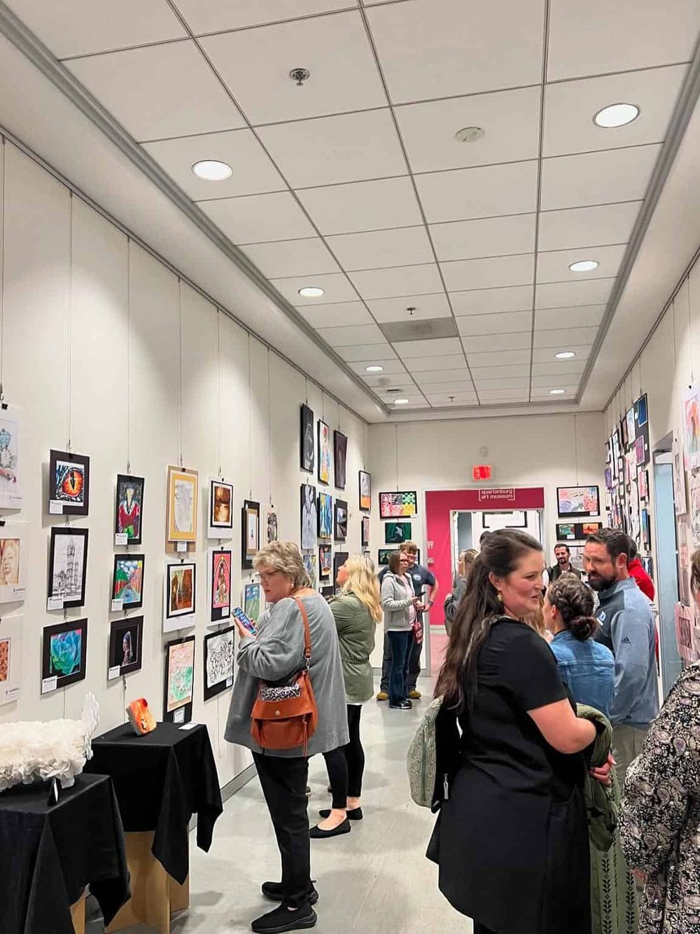Colorful art gallery showcasing vibrant artwork at Quest for Directions art exhibition.