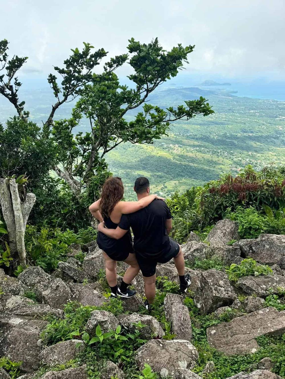 Breathtaking mountain view with a couple hiking and exploring nature trails. Adventure awaits in scenic outdoor locations.