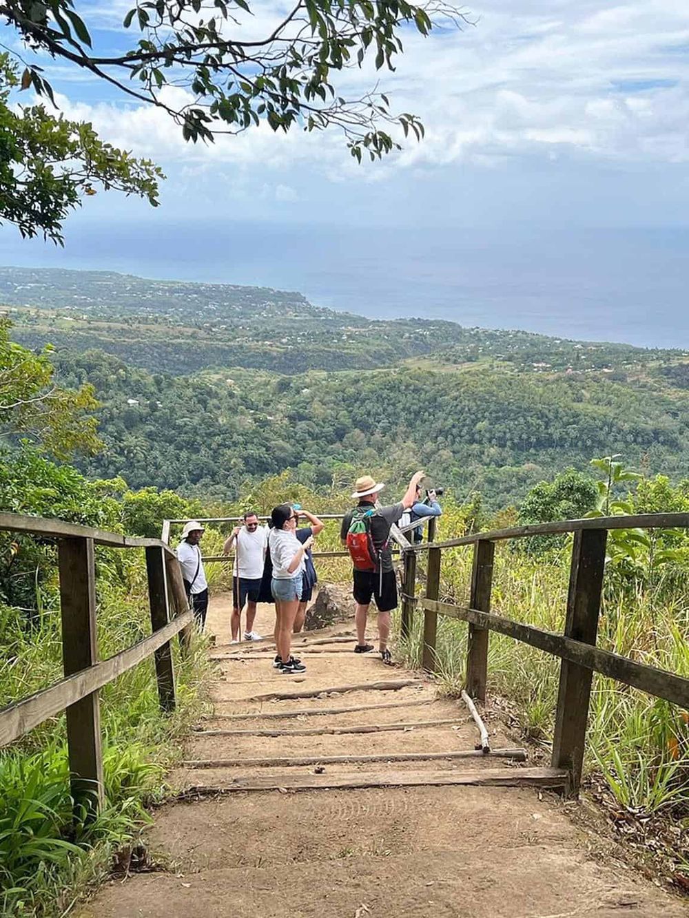 Scenic hiking trail with tourists enjoying panoramic views and nature exploration.