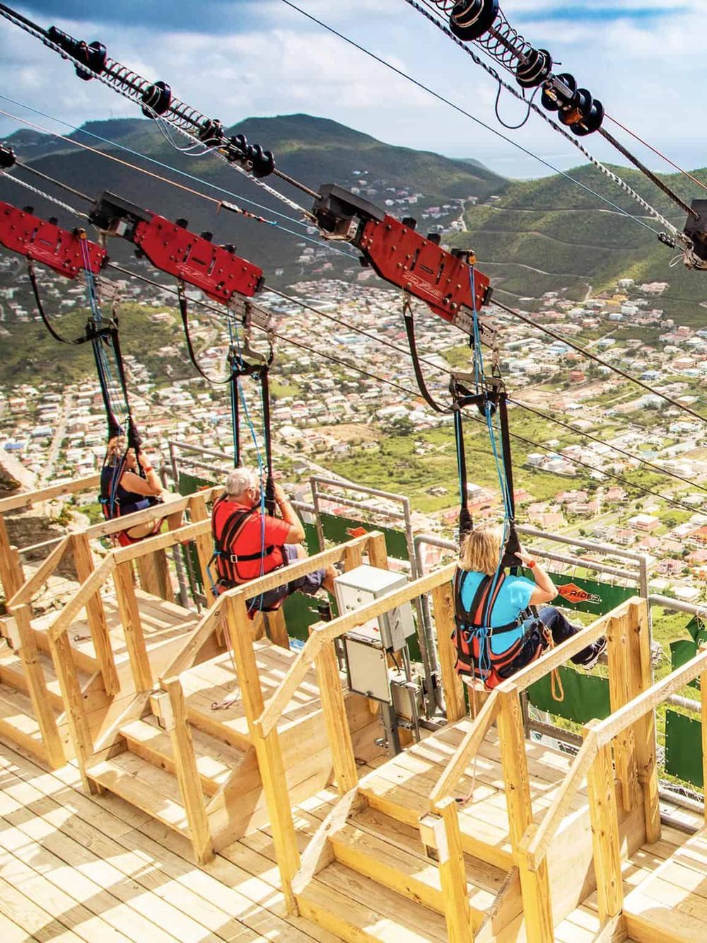 Thrilling zipline adventure above scenic hills and town, perfect for outdoor recreation and adrenaline rush.