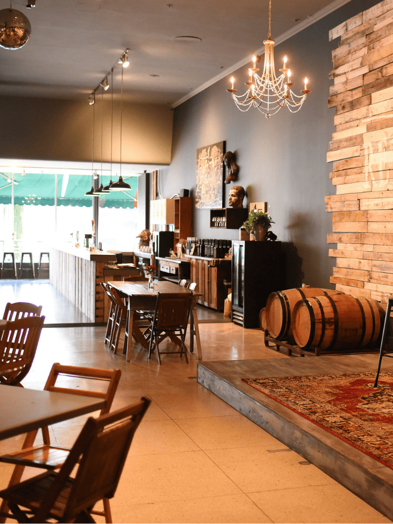 Cozy modern wine bar with wooden decor and vintage barrels for tasting experiences.