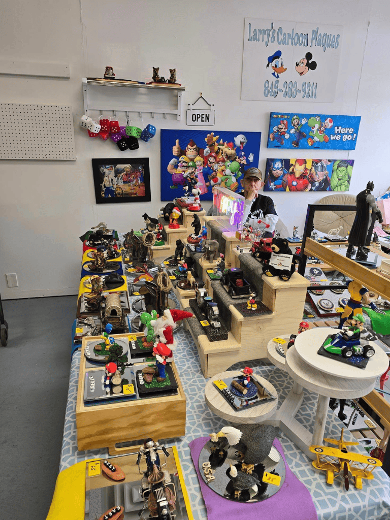 Colorful display of vintage toys and collectibles at QuestForDirections booth with cartoon posters and plush items.