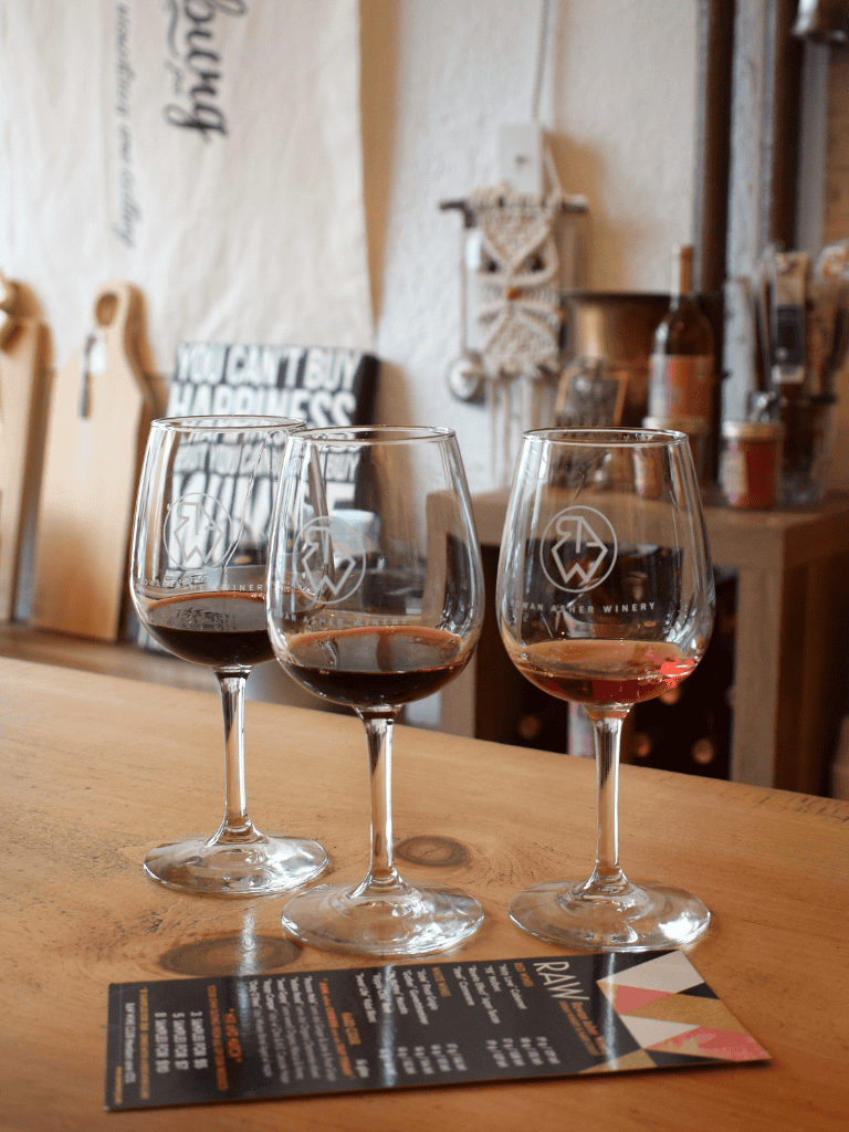 Delicious red wine in wine glasses at a cozy winery tasting room.