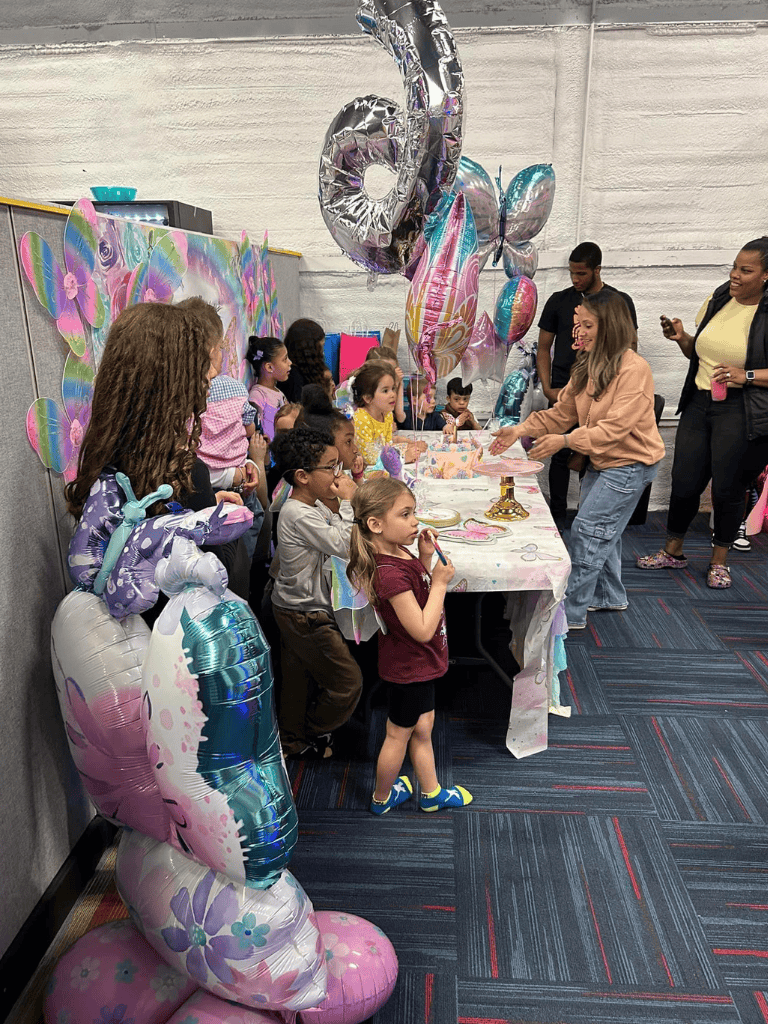 Colorful children's birthday party with balloons and cake, kids celebrating with friends.