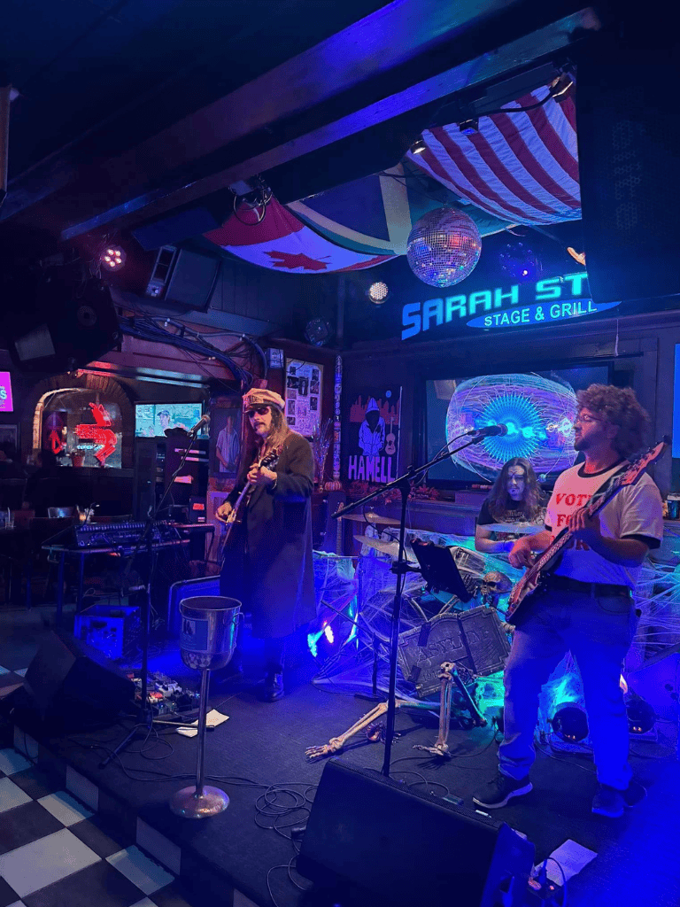 Live music performance at Sarah Street Stage and Grill in a vibrant bar setting.