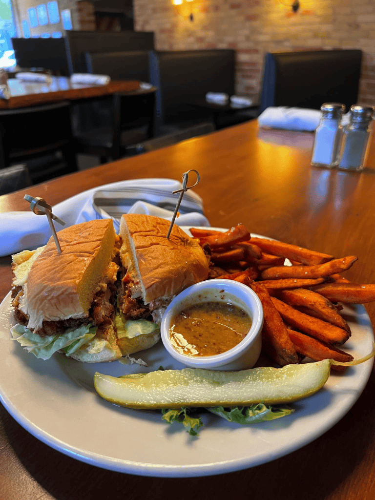Grilled sandwich with sweet potato fries and dipping sauce at QuestForDirections restaurant.