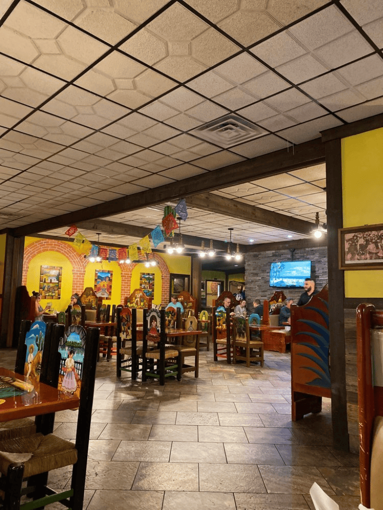 Festive Mexican restaurant interior with colorful decorations and traditional artwork, inviting relaxed dining experience.