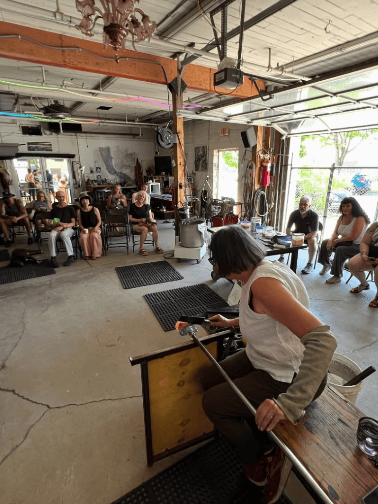 Indoor gathering at QuestForDirections studio, featuring a diverse group engaged in a workshop or discussion.