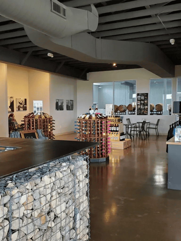 Modern tasting room with wine displays and seating at QuestForDirections winery.