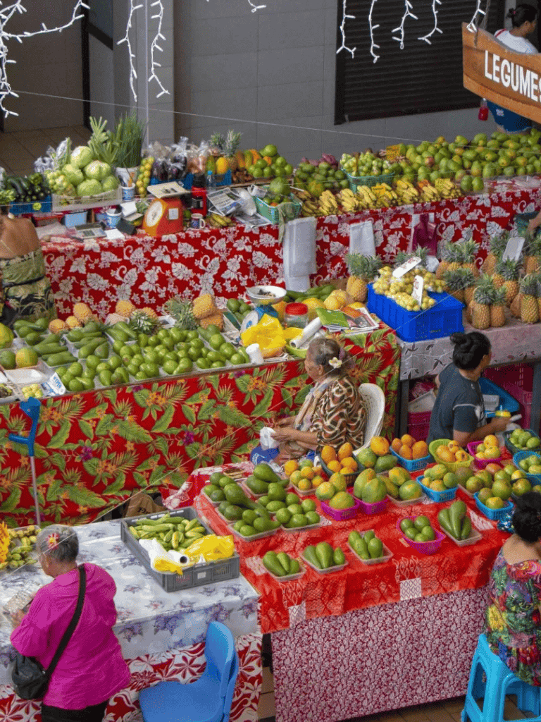 Fresh tropical fruits at a vibrant outdoor farmers market stall.