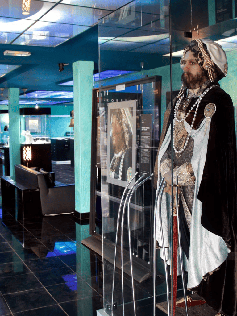 Zanzibar history exhibit with traditional attire display in modern museum setting, showcasing cultural heritage and historical artifacts.