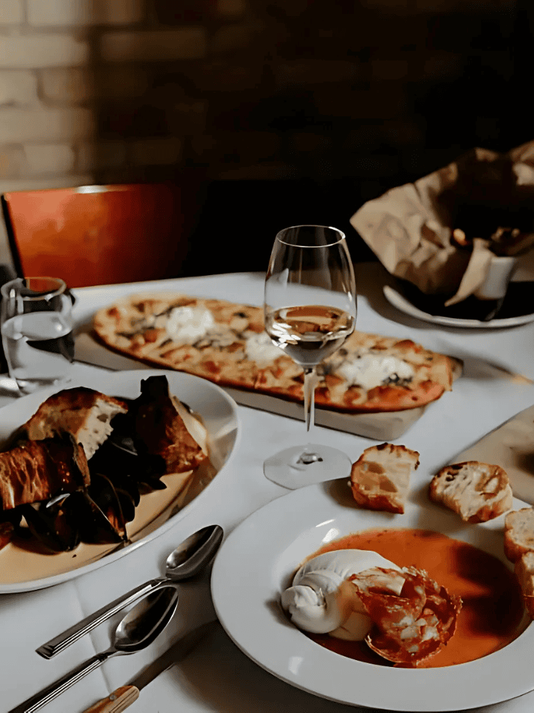 Delicious Italian pizza, pasta, and wine served at an elegant restaurant for dining experience.
