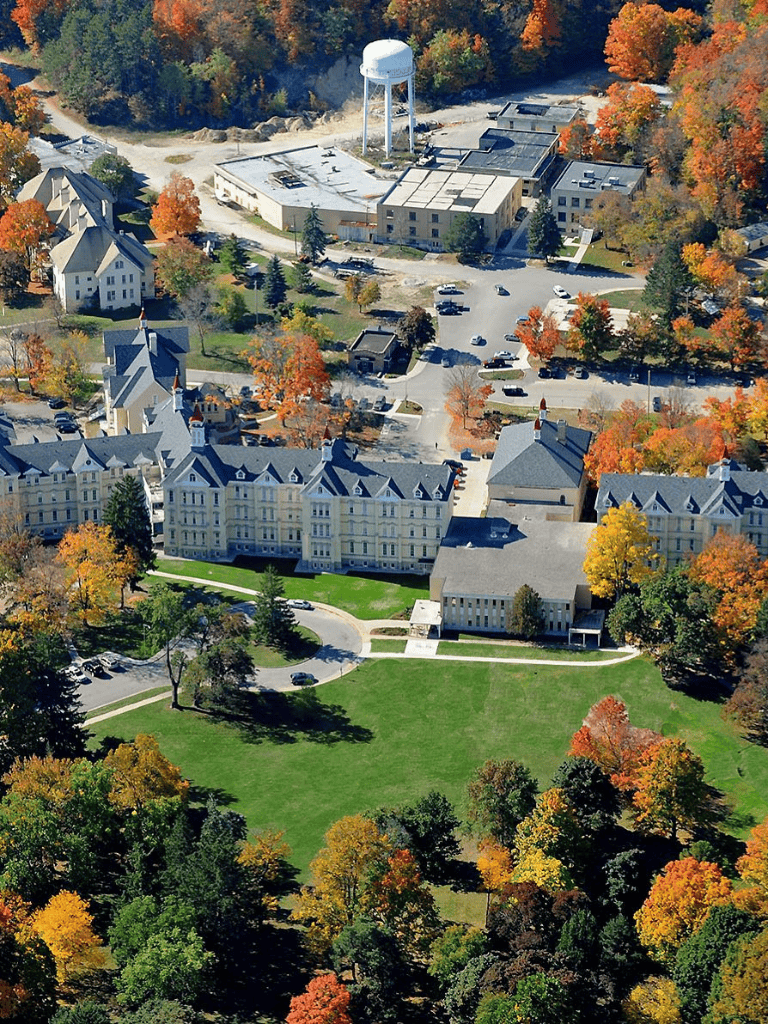 Historic hotel surrounded by colorful autumn trees at QuestForDirections.
