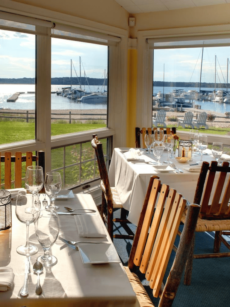 Boat marina waterfront dining scenic view of water and sailboats from indoor restaurant.