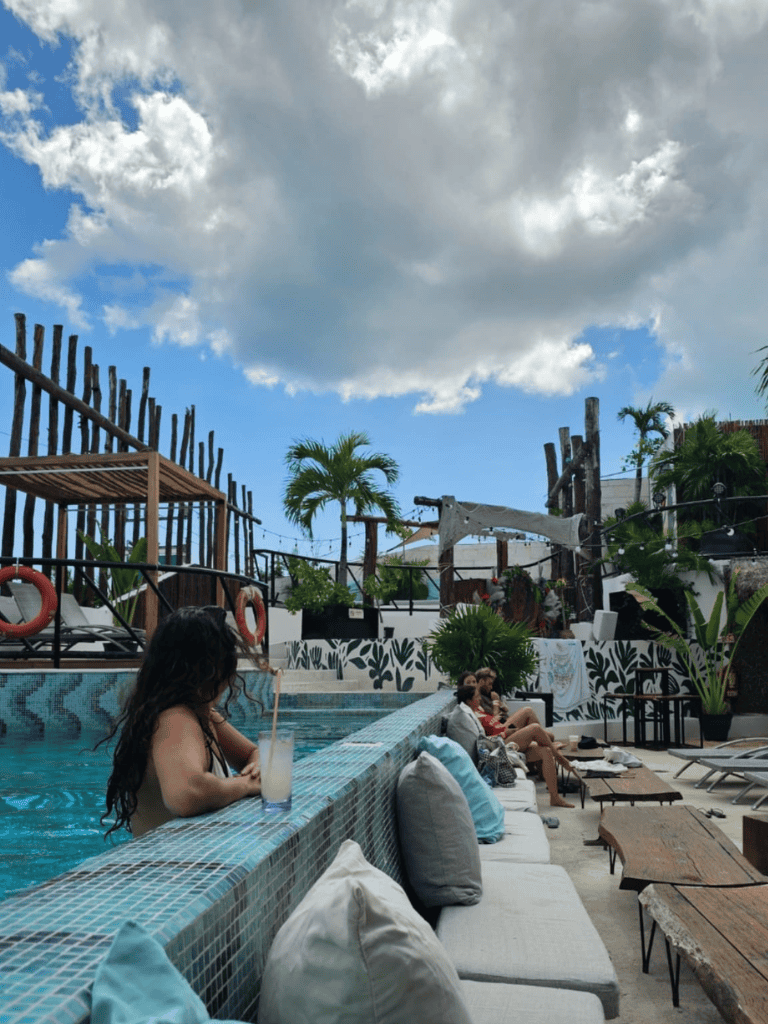Relaxed poolside lounge area with people enjoying drinks and sunshine at QuestForDirections.