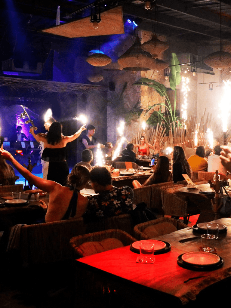 Exciting firework performance at a tropical-themed restaurant with live entertainment and vibrant atmosphere.