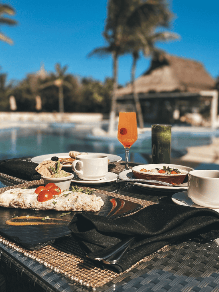 Luxurious poolside dining with vibrant cocktails and gourmet dishes at QuestForDirections.
