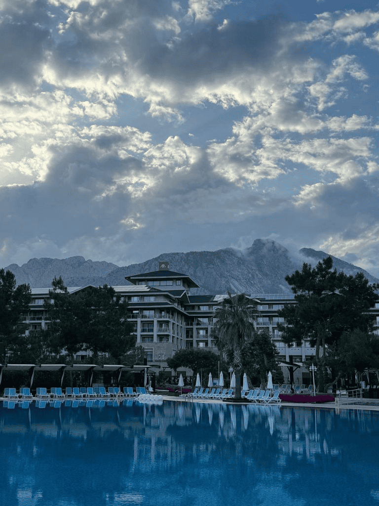 Serene hotel pool overlooking mountain landscape and lush greenery at QuestForDirections.