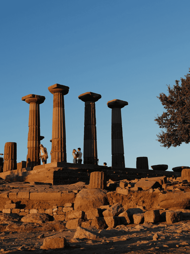 Ancient Greek ruins with columns at sunset, exploring historical sites and architecture for travel enthusiasts.