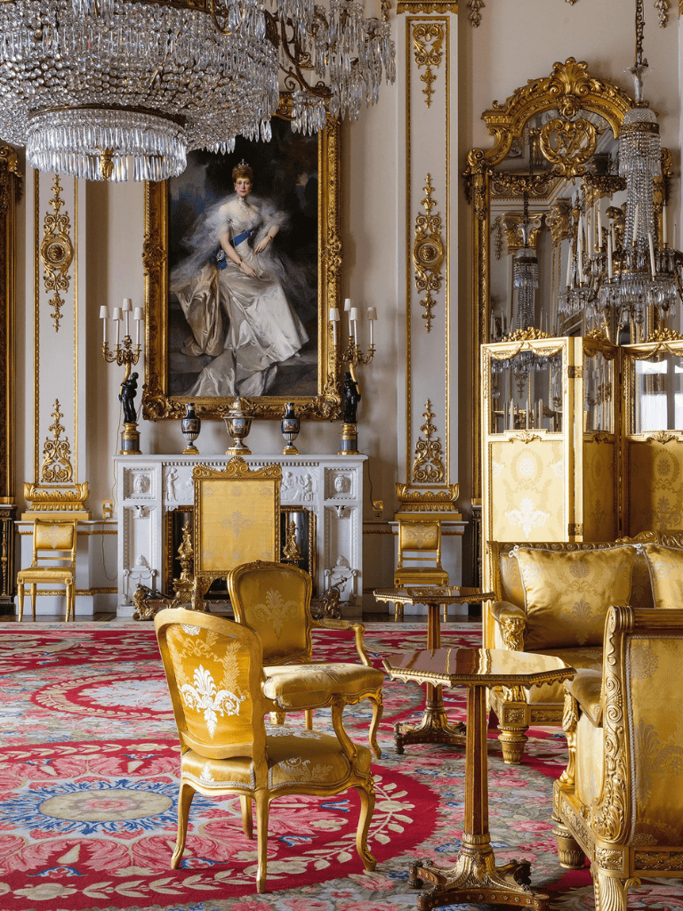 Luxurious royal interior with gold accents, chandelier, and elegant antique furniture.