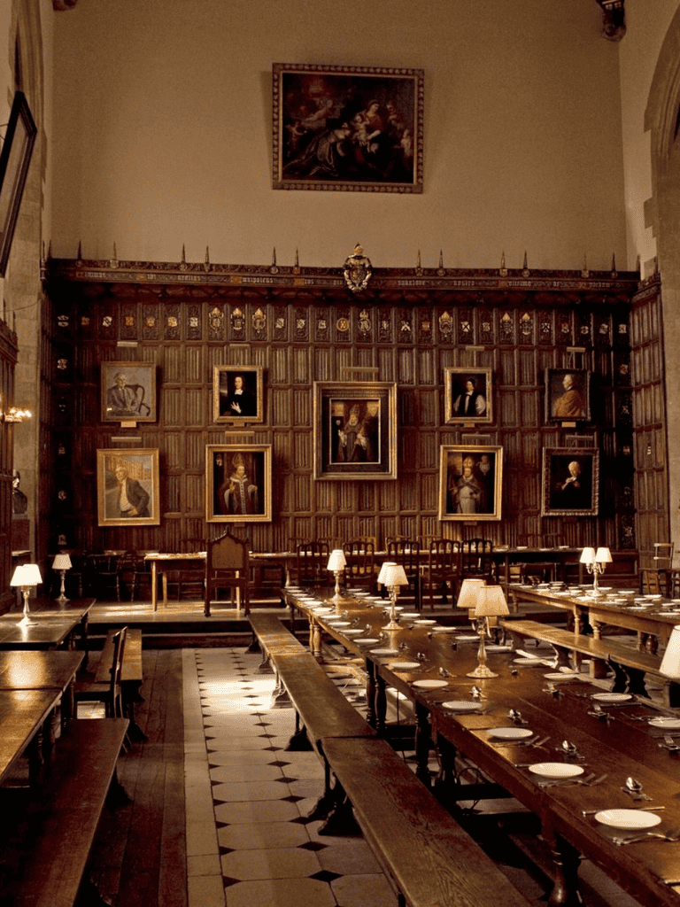 Elegant historic library room with wooden paneling and framed portraits, perfect for study or gatherings.