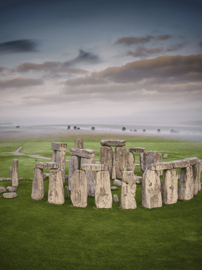 Mysterious ancient Stonehenge monument at sunrise or sunset, iconic prehistoric archaeological site.