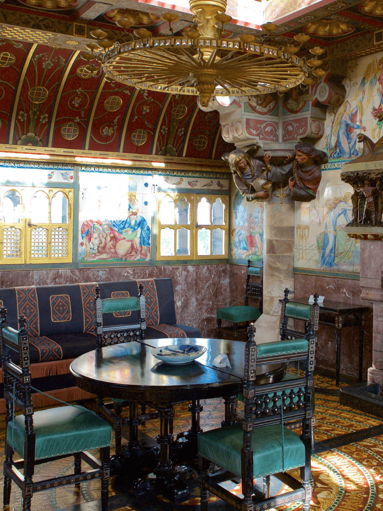 Intricate interior of a historic church with colorful murals, stained glass windows, and antique furniture.