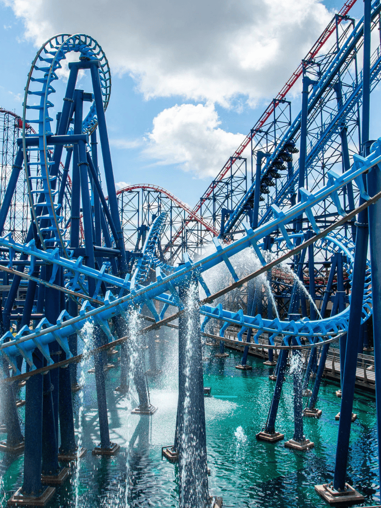 Thrilling blue roller coaster at QuestForDirections amusement park, water park attractions.