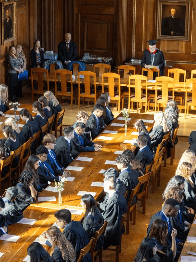 Graduation ceremony with students in caps and gowns at QuestForDirections event in a grand hall.