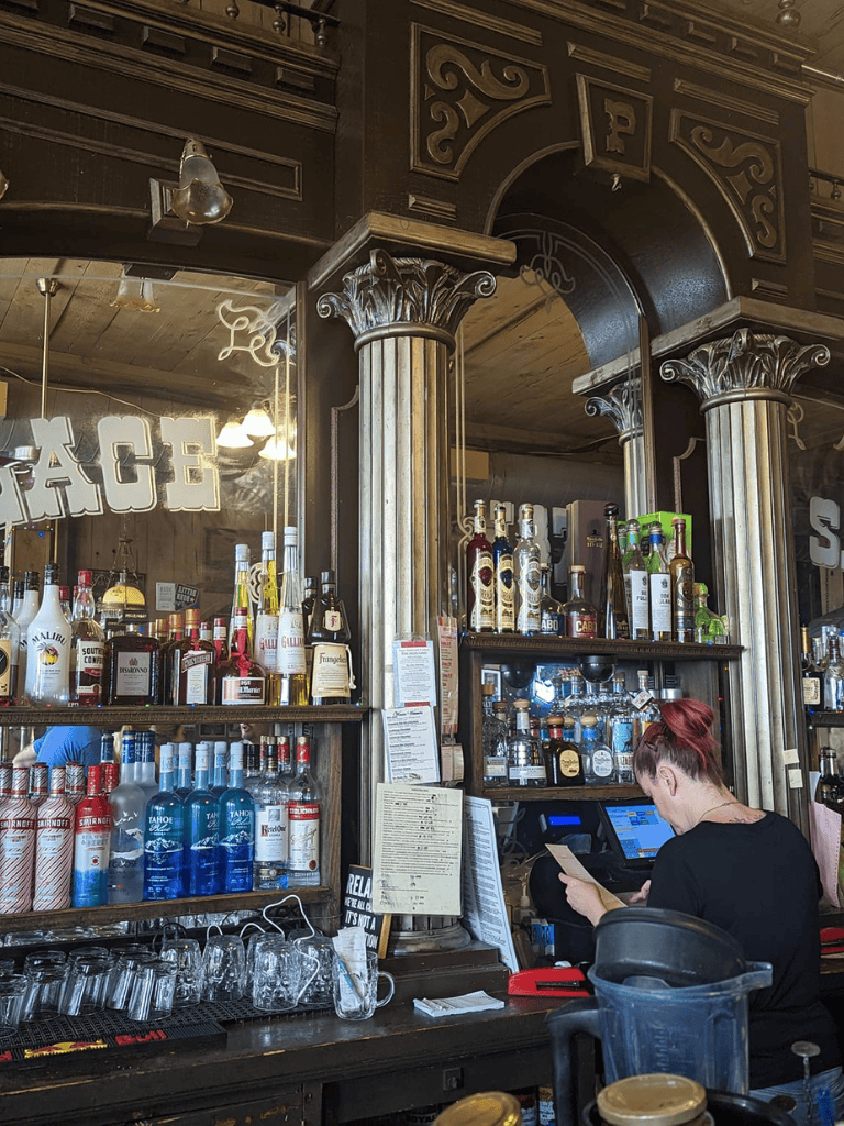 Premium whiskey and cocktail selection at QuestForDirections bar in a vintage tavern setting.
