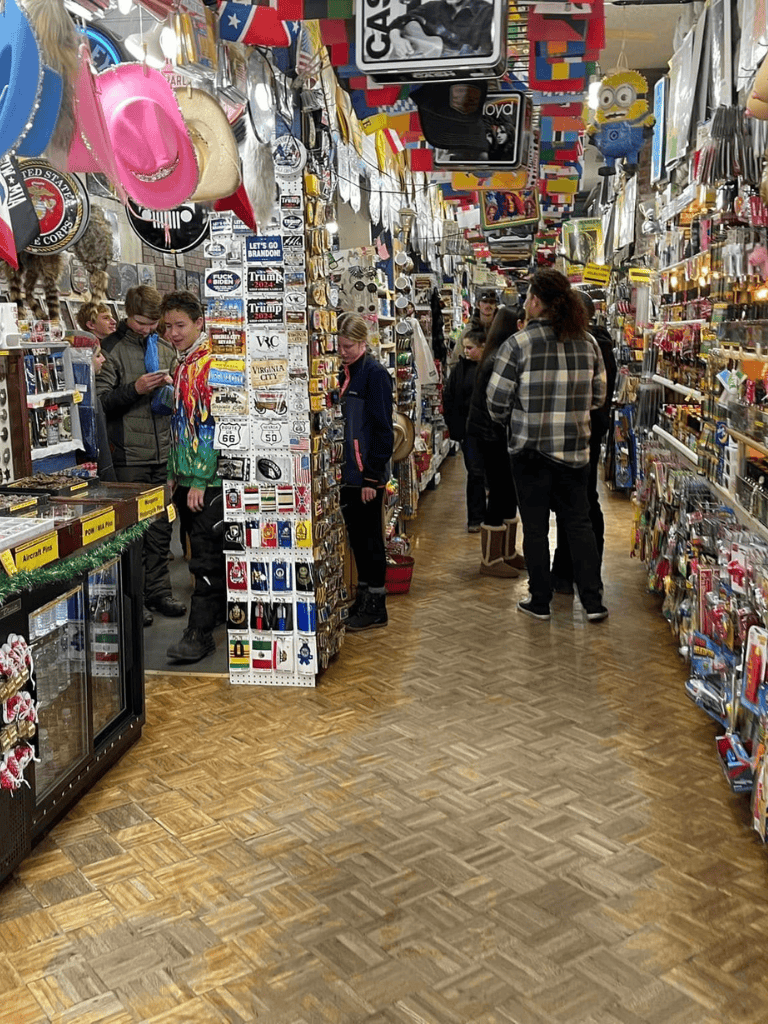 Colorful souvenir shop filled with visitors exploring unique gifts and memorabilia | QuestForDirections.