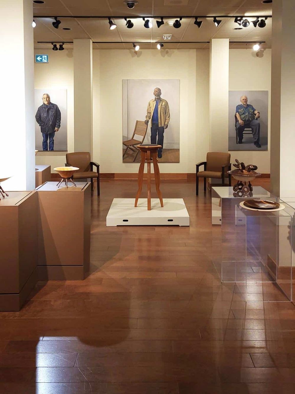 Vivid portrait art exhibit showcasing diverse human figures at Quest for Directions museum.