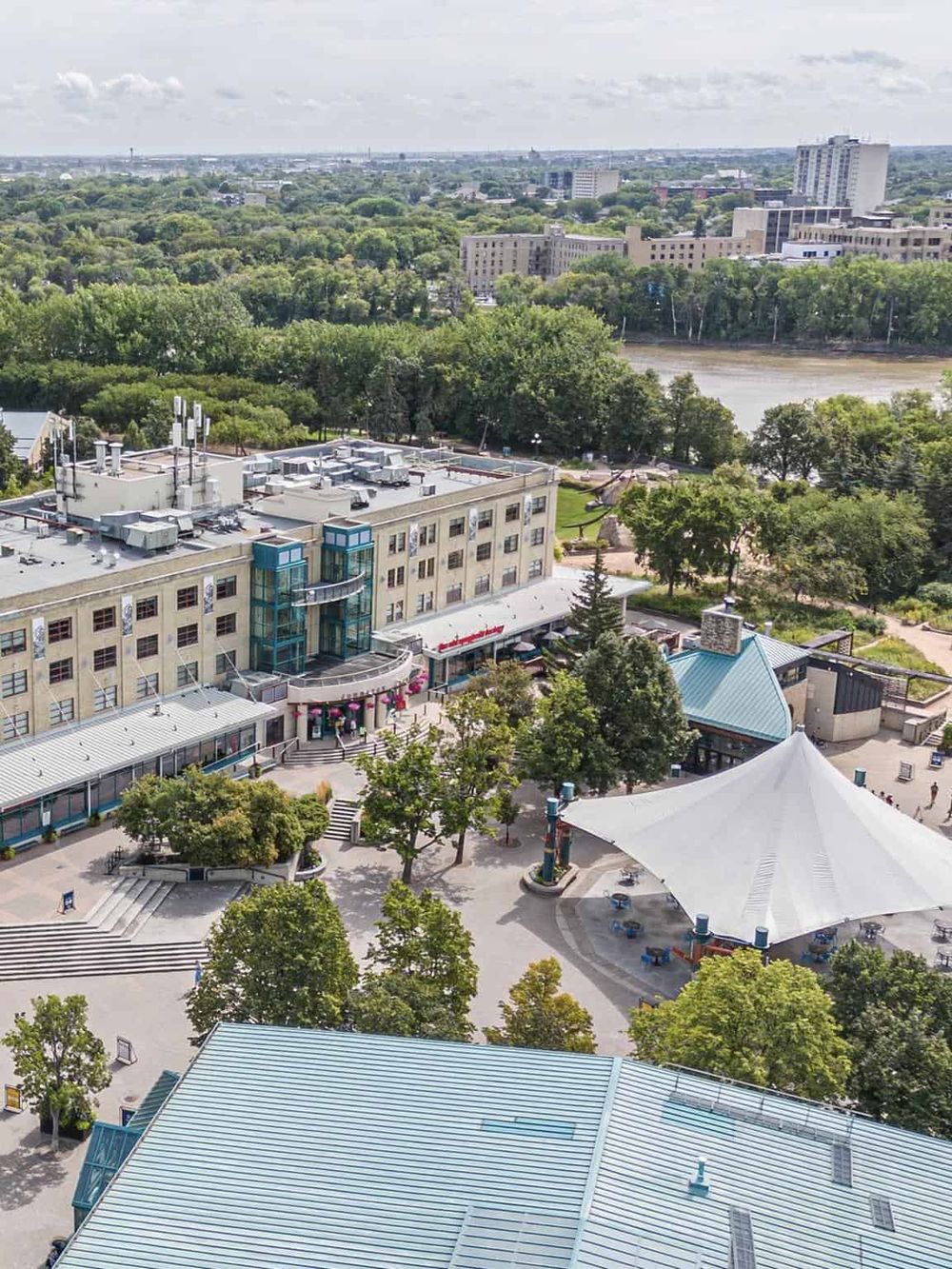 Vivid cityscape view from above showcasing QuestForDirections location with green parks and urban buildings.