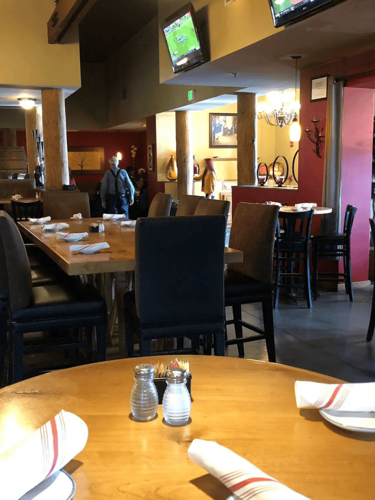 Enjoying a warm, inviting restaurant interior with stylish decor and multiple TV screens for entertainment.