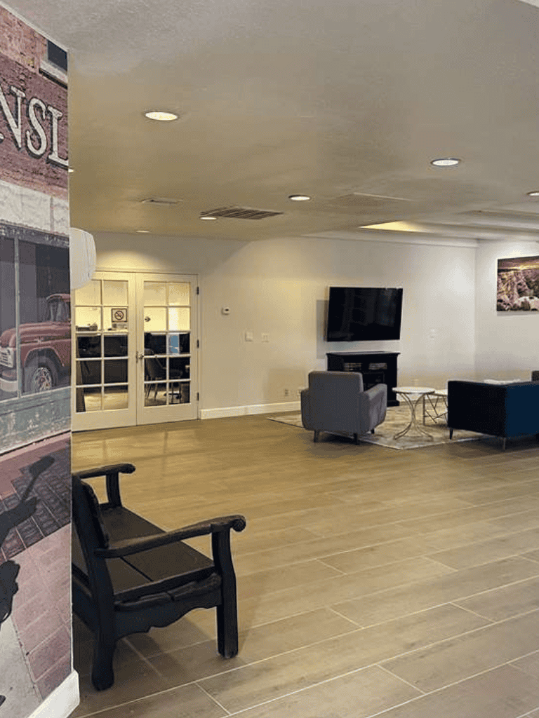 Modern hotel lobby with seating area, TV, and welcoming atmosphere for travelers.