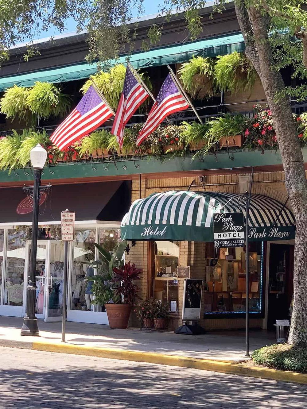 American flags and greenery outside Park Plaza Hotel, promoting local attractions and hospitality services.