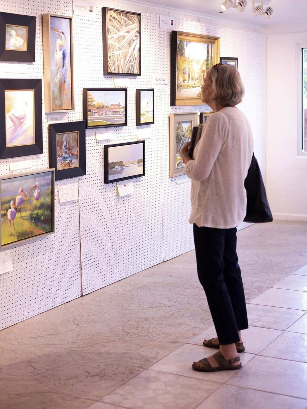 Colorful artwork displayed at an art gallery or exhibit.