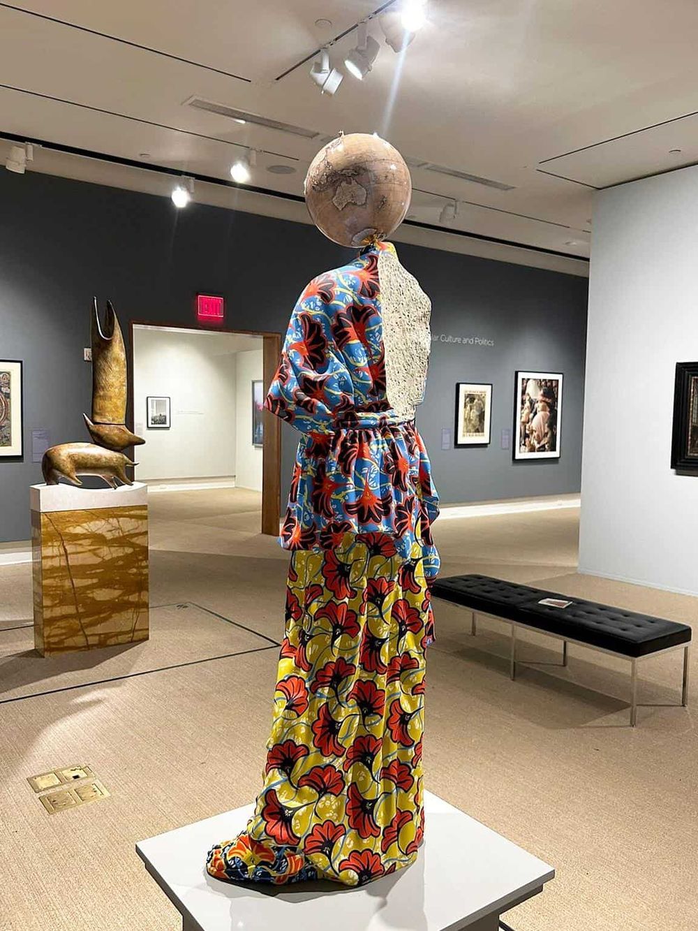 Colorful artistic sculpture with patterned fabric in art gallery, modern artwork display, vibrant museum decor.