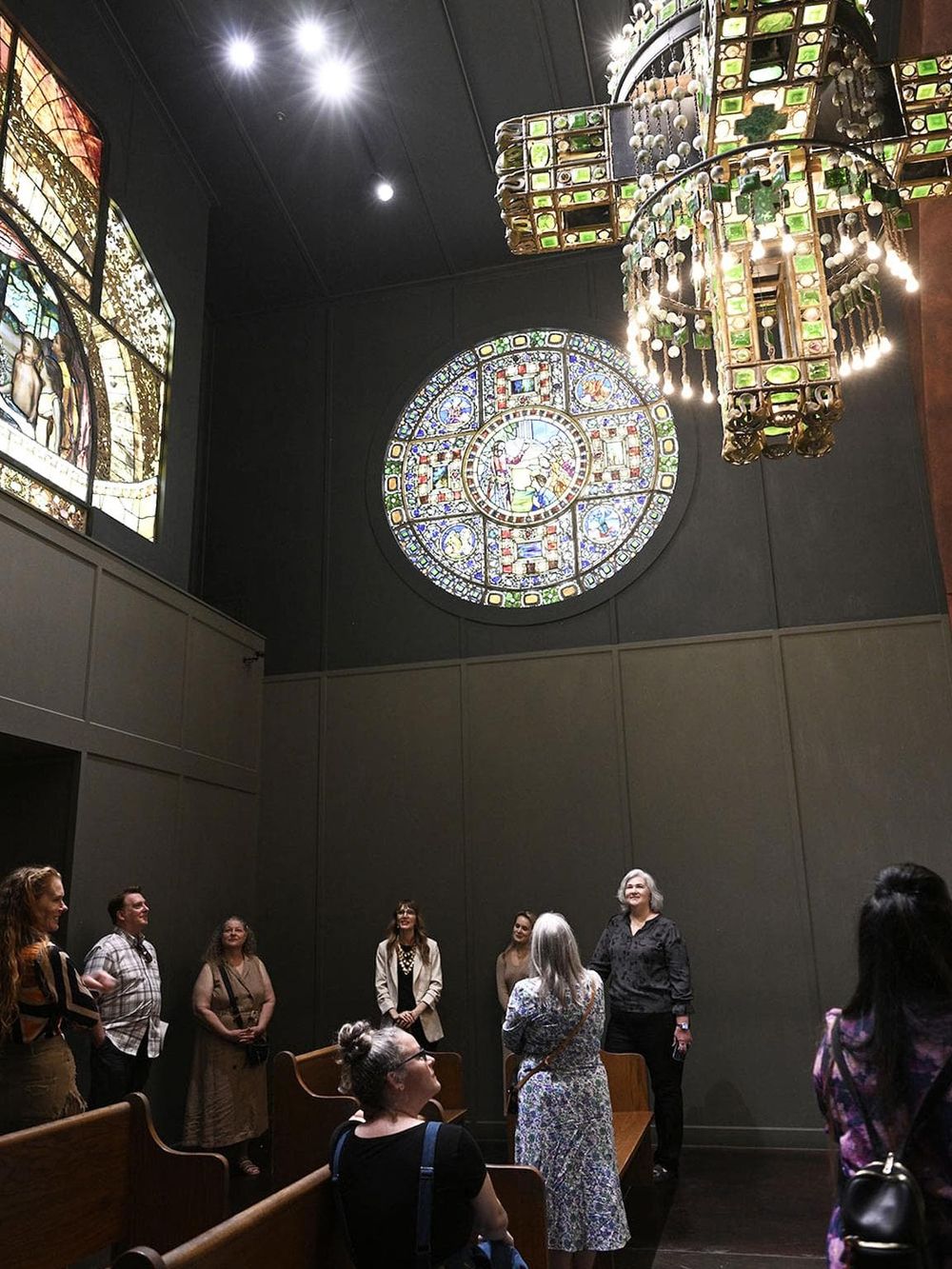 Intricate stained glass and historical chandeliers in a church or museum setting.