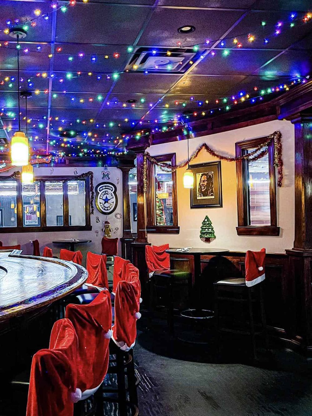 Colorful Christmas lights with Santa hats decor in a cozy restaurant setting.